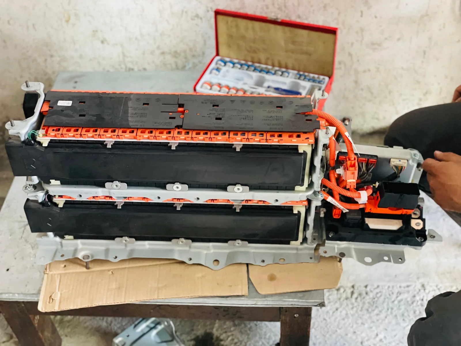 Hybrid battery pack opened on the workbench for cell testing and repair