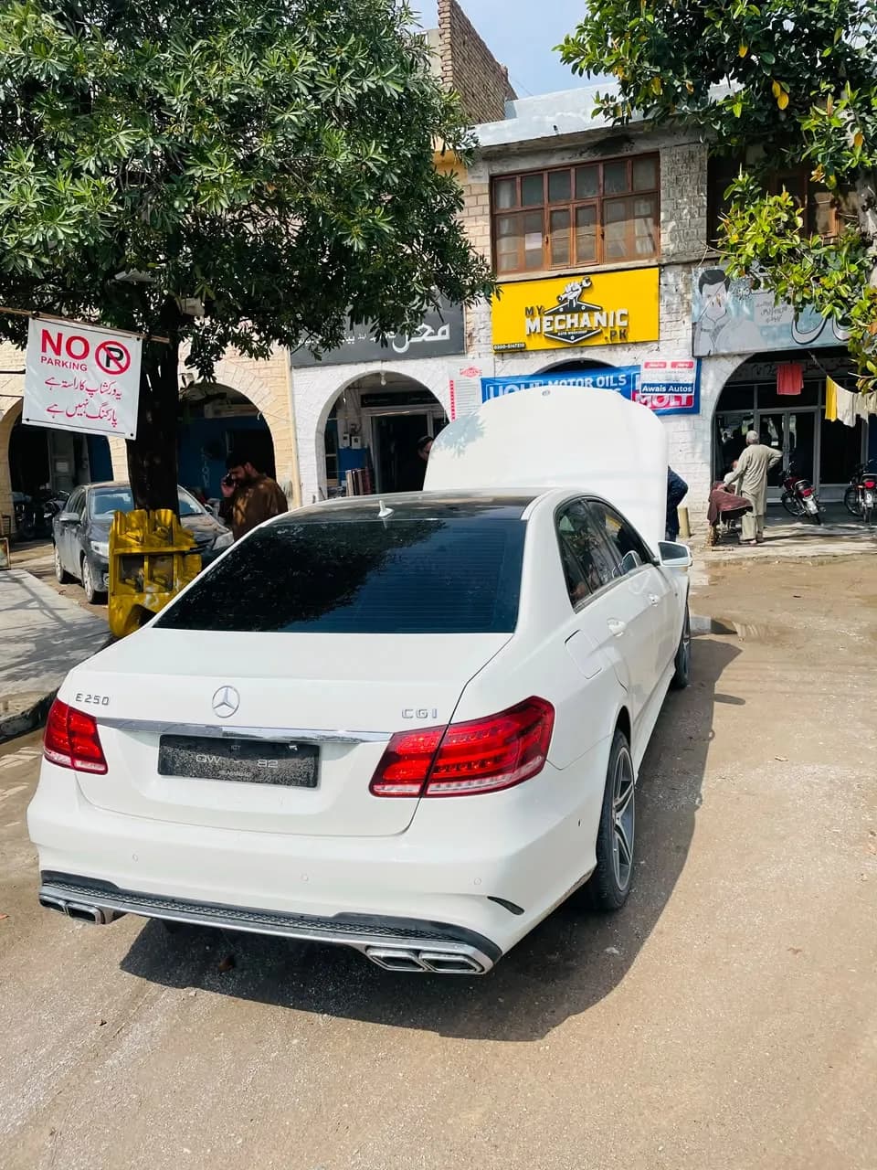 White Mercedes-Benz E-Class parked in front of the My Mechanic workshop