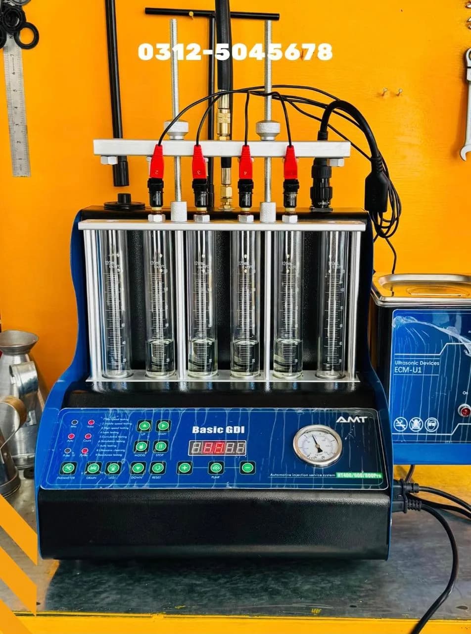 AMT Basic GDI fuel injector tester and cleaner with six injectors mounted over glass flow tubes, beside an ultrasonic cleaning bath
