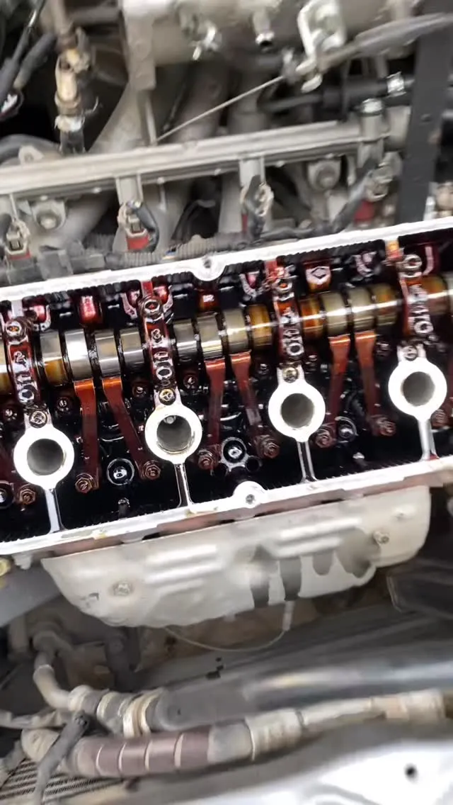 Exposed camshaft and valve train of an engine during inspection