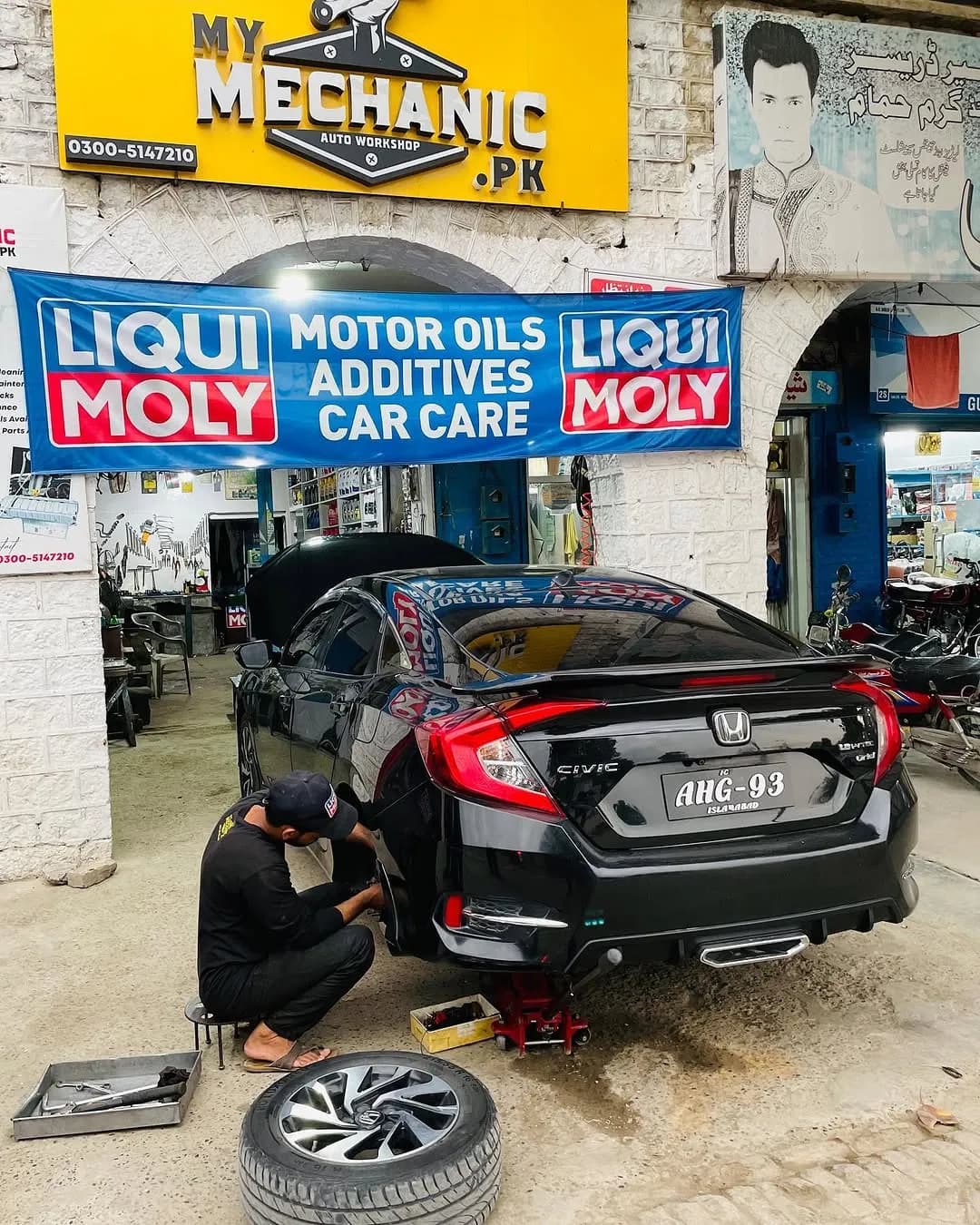 My Mechanic.pk sign above a blue Liqui Moly 'Motor oils, additives, car care' banner at the shop entrance